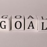 White letter blocks spelling 'Goal' on a neutral backdrop, ideal for business themes.